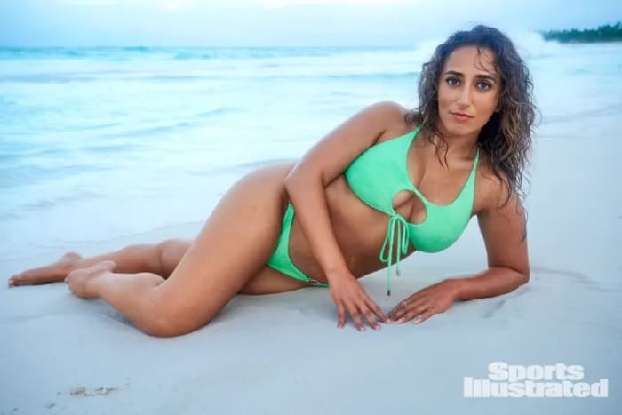 Sarafina El-Badry Nance lays on the sand in a mint green bikini.